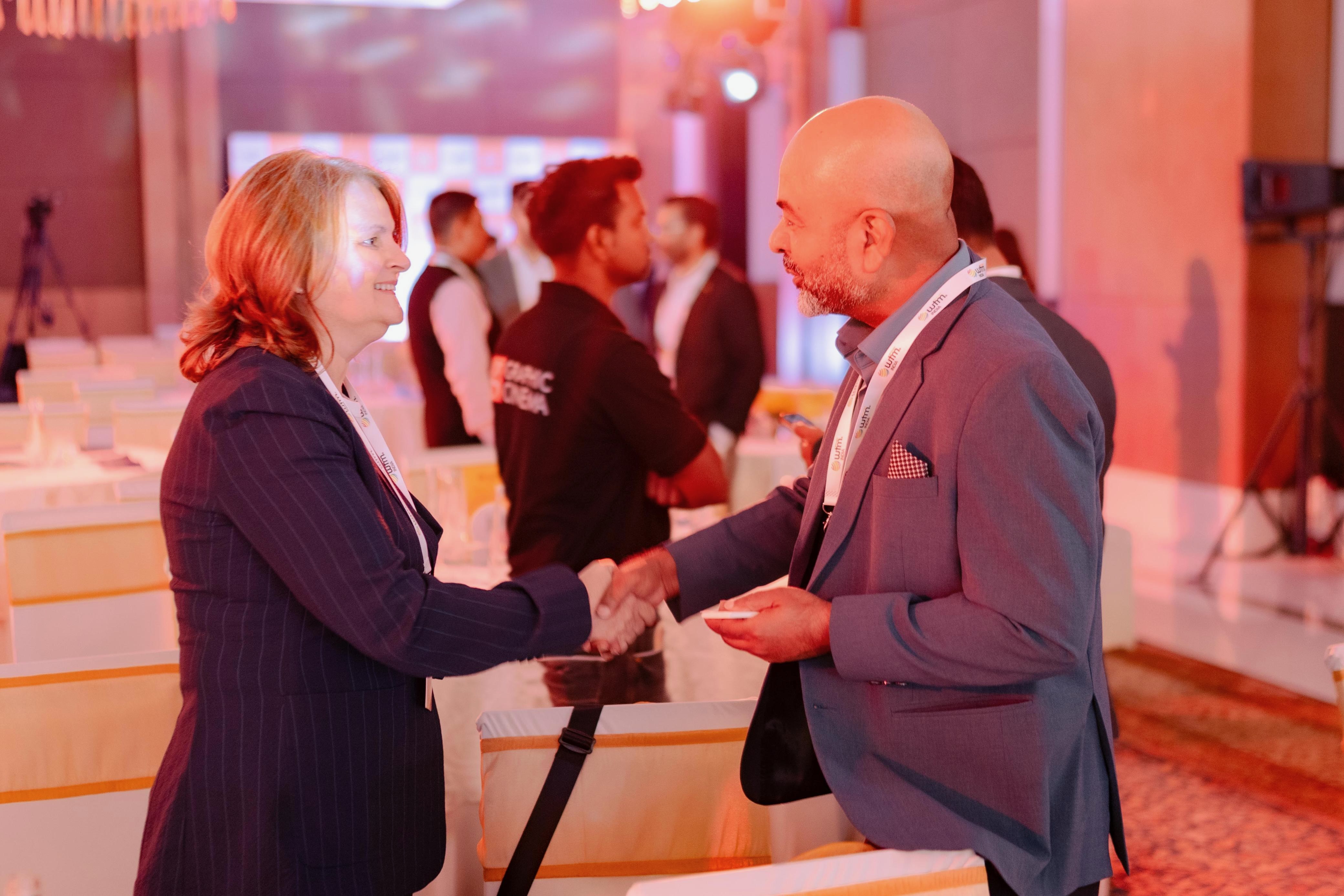 Sunil Mishra greeting a fellow travel professional at an industry event