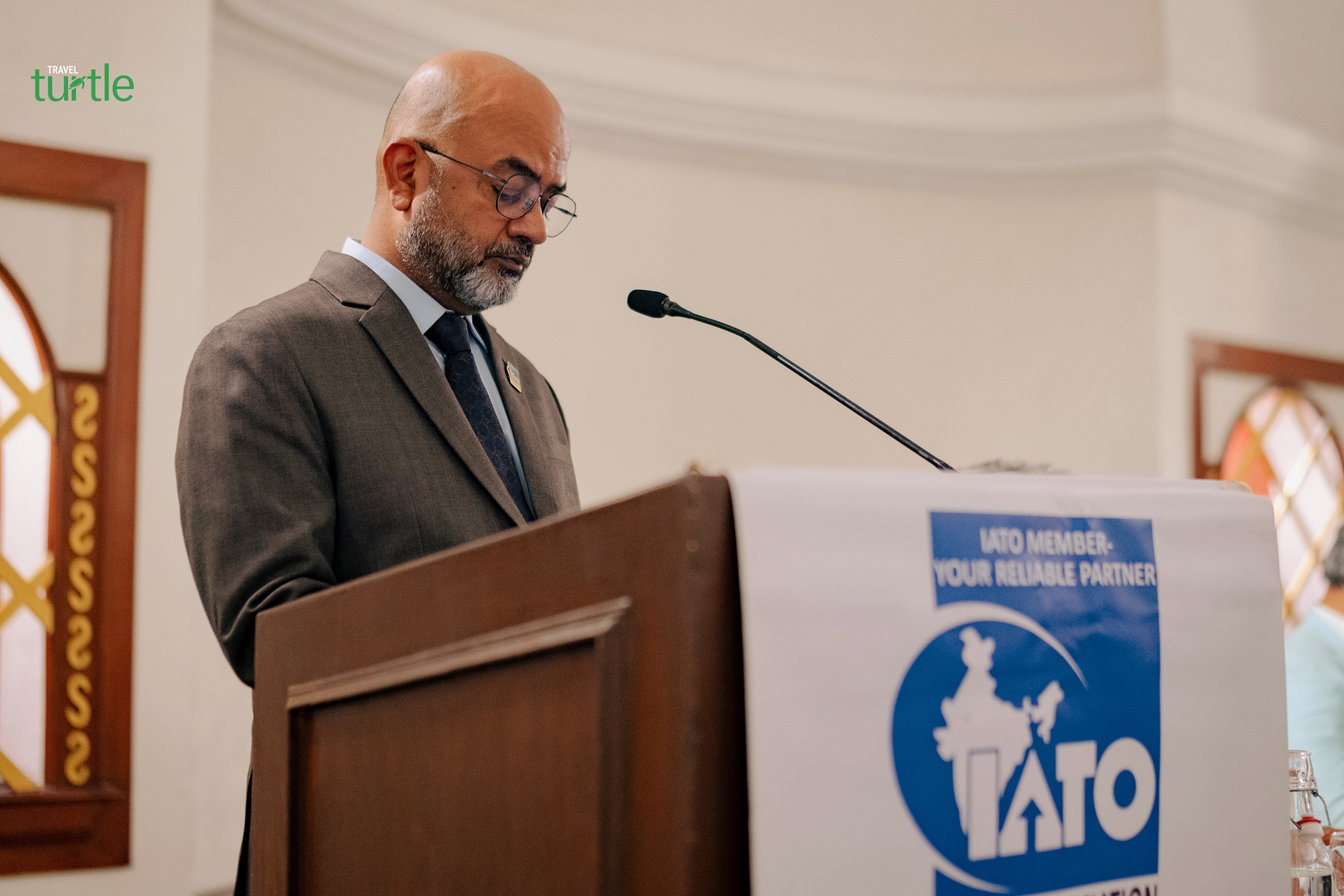 Sunil Mishra addressing an IATO gathering at the lectern